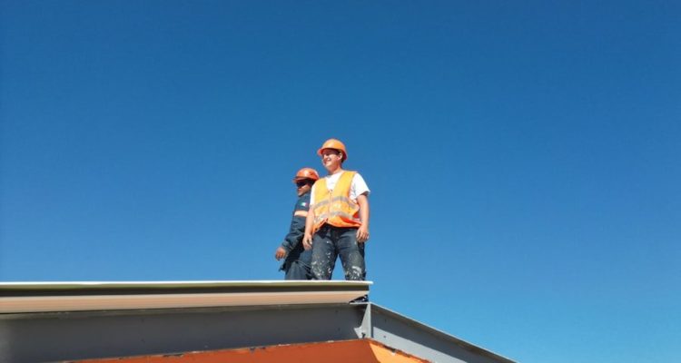 A man standing on top of a skateboard ramp